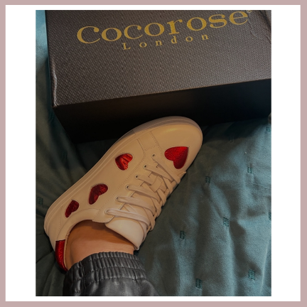 white leather trainers with red heart embellishments