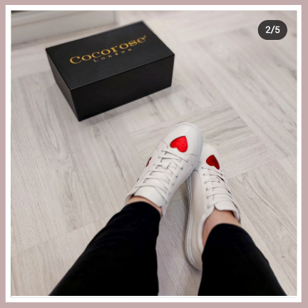 metallic red hearts against the classic white leather trainers with dark pants
