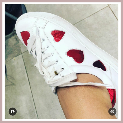 white leather trainers with red heart accents
