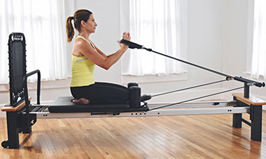 Pilates Reformer Workout Exercises Woman Brunette At Gym Indoor