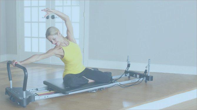 aeropilates expert marjolein brugman performing a pilates pose on aeropilates pilates reformer