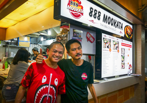 The owners posing at the 888 Mookata Tampines Branch
