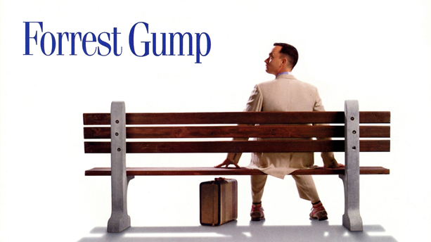 Forrest Gump, the protagonist of the movie of the same name, sitting on a bench with his suitcase