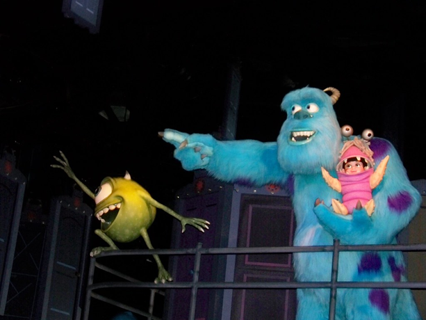A picture of Mike and Sulley, main characters of the Disney Pixar movie Monsters Inc with a human child, Boo