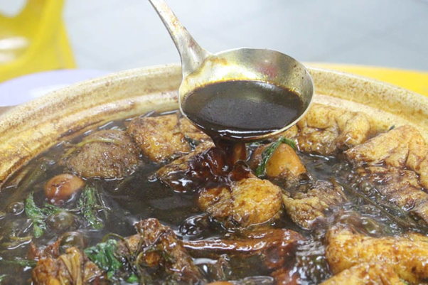 Hotpot broth resembling dark soy sauce due to its dark complexion