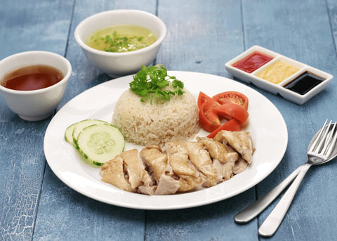 Image of chicken rice dish with sauce and soup.