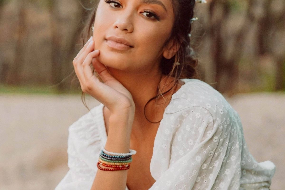 woman in flower crown with chakra bracelets