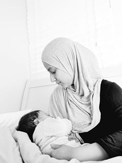 muslim-woman-in-hijab-breastfeeding-baby-holding-hand-bon-and-bear