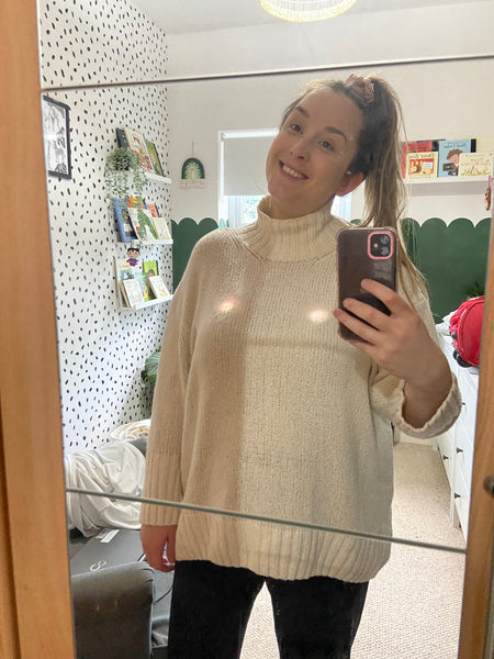 mum-smiling-in-mirror-with-elvie-breastpumps-under-top-bon-and-bear