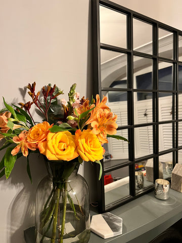 bloom-and-wild-orange-flowers-in-a-grey-vase-with-mirror-bon-and-bear
