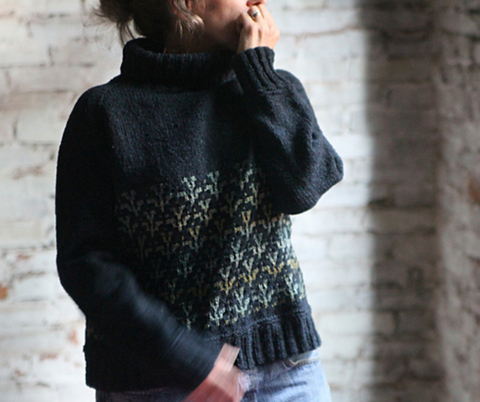 Thea Coleman's Western Rose Dark blue long sleeved sweater with turtle neck and mosaic pattern on the front.