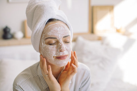 Woman putting on a face mask in her morning routine