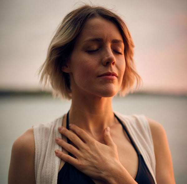 woman taking a deep breath as reishi has helped her lung health
