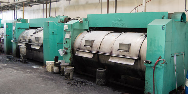 large teal dying machines at our dye house in Los Angeles