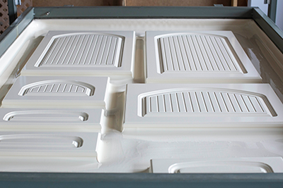 MDF cabinet doors with laminated white RTF prior to being separated