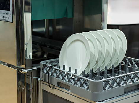 Rack of dishes ready to go into hot water sanitation dishwasher