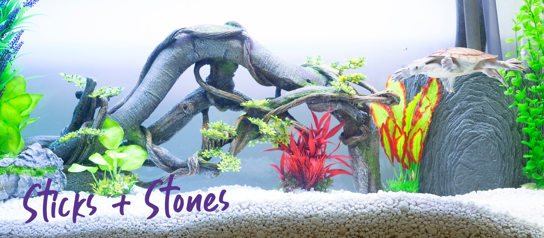 fish tank decoration with logs and stones and bright silk plants