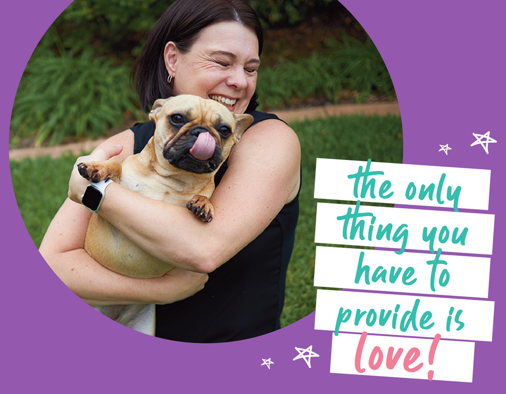 woman hugging a small dog