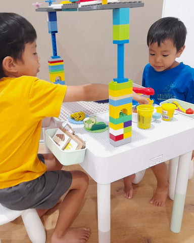 Kids playing with Duplo table