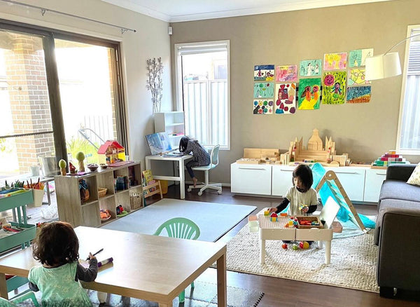 Kids living room play area with artwork on wall