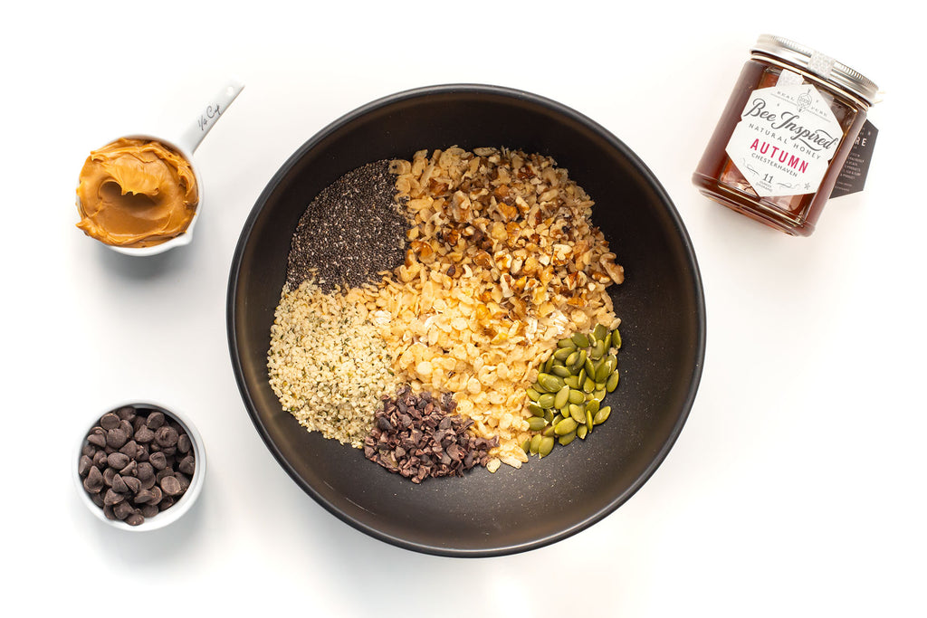 a mixing bowl fill with ingredients for no-bake peanut butter granola bars