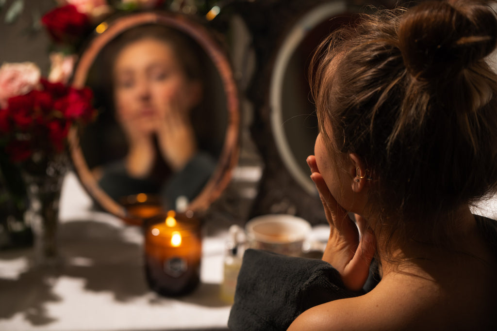 Woman looking at herself in a mirror