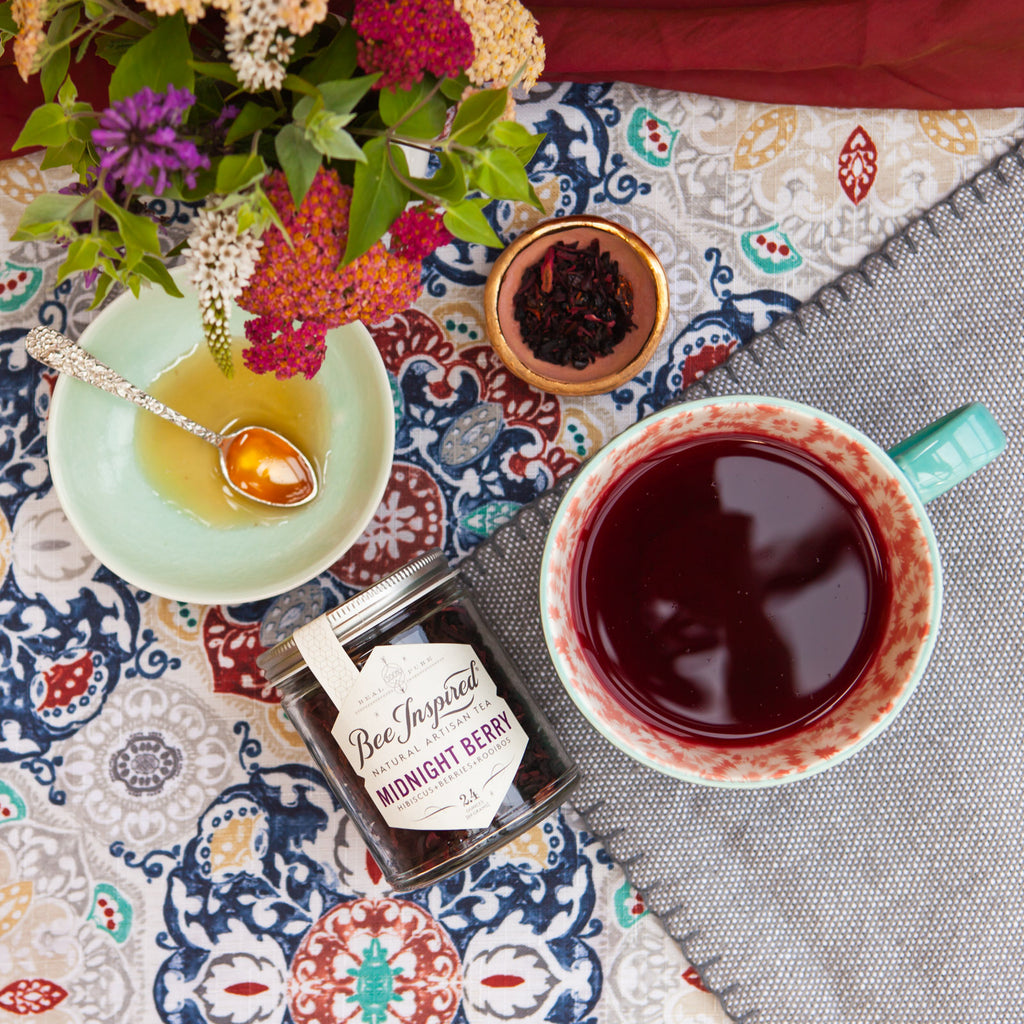 midnight berry tea on pattern tablecloth with honey