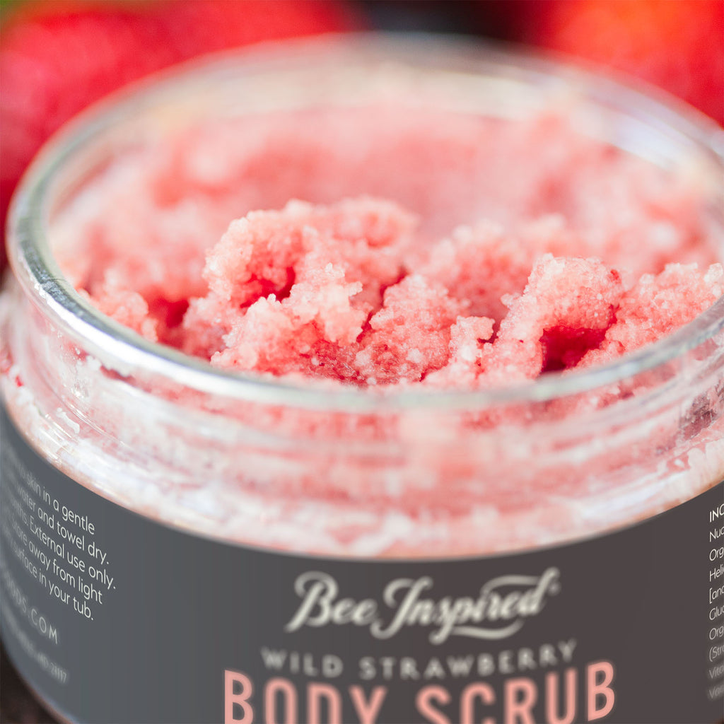 close up of an open container of wild strawberry body scrub