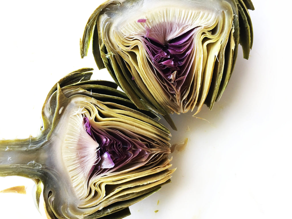 Two halves of an artichoke laying next to each other