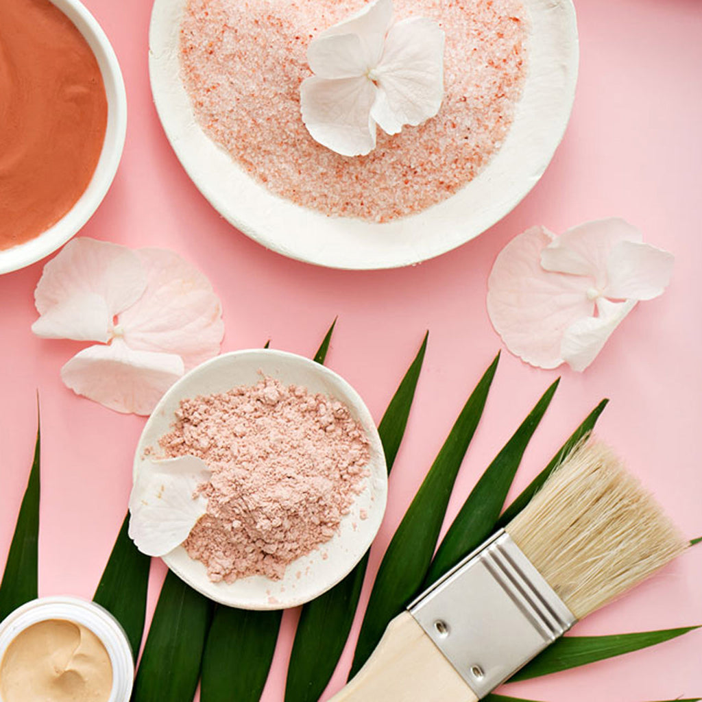 Bee well DIY face mask in a white bowl next to a brush