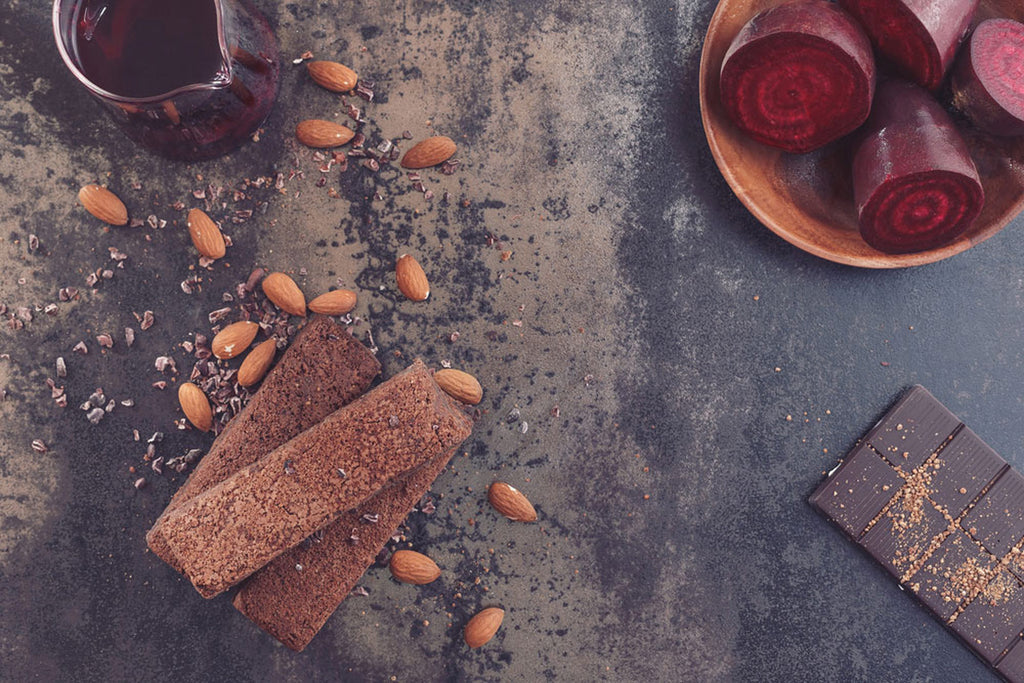 Beet root brownies surrounded by almonds and beets