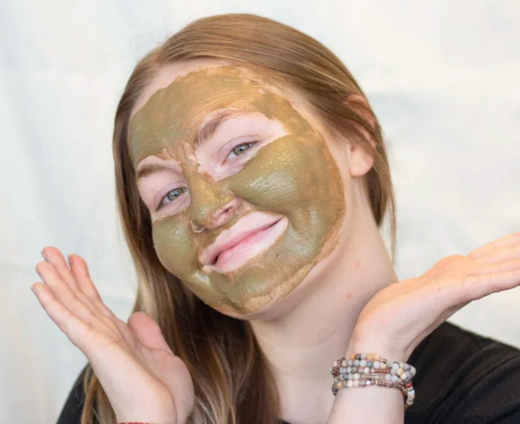 Woman using Bee Inspired Sea+Tea mask on her face