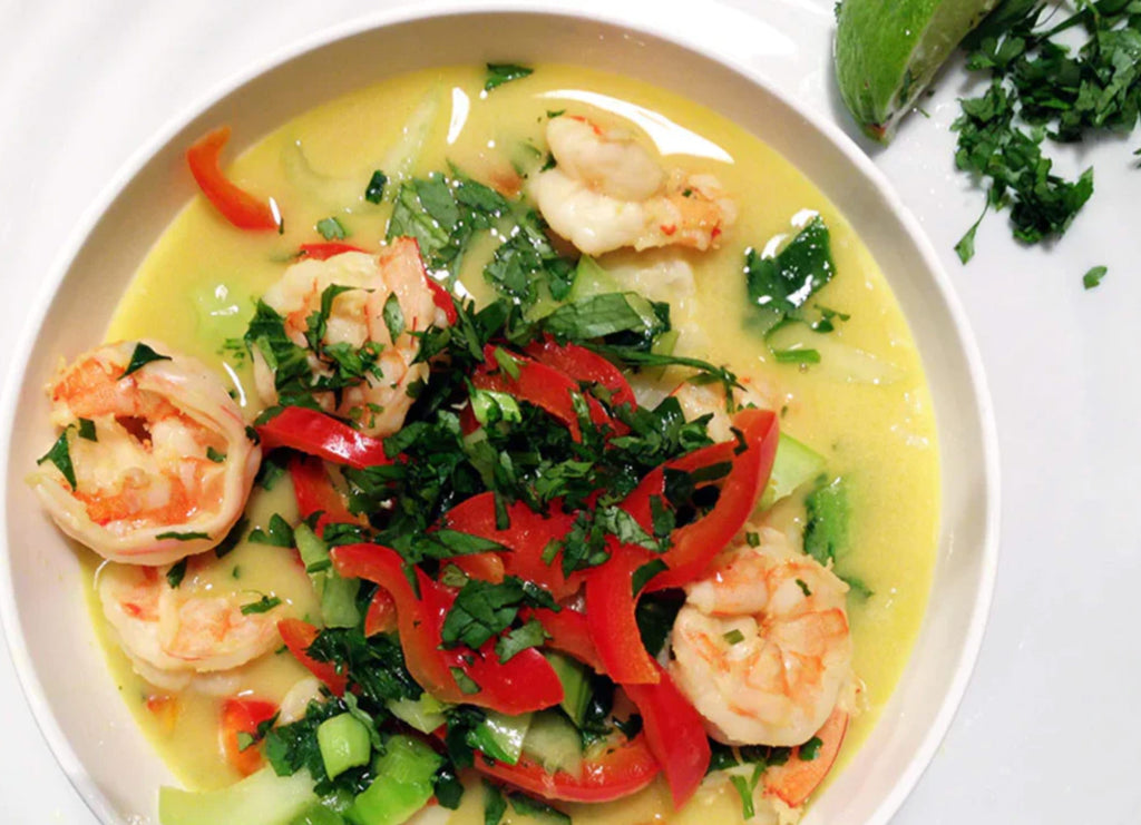 Shrimp on a plate with vegetables and broth