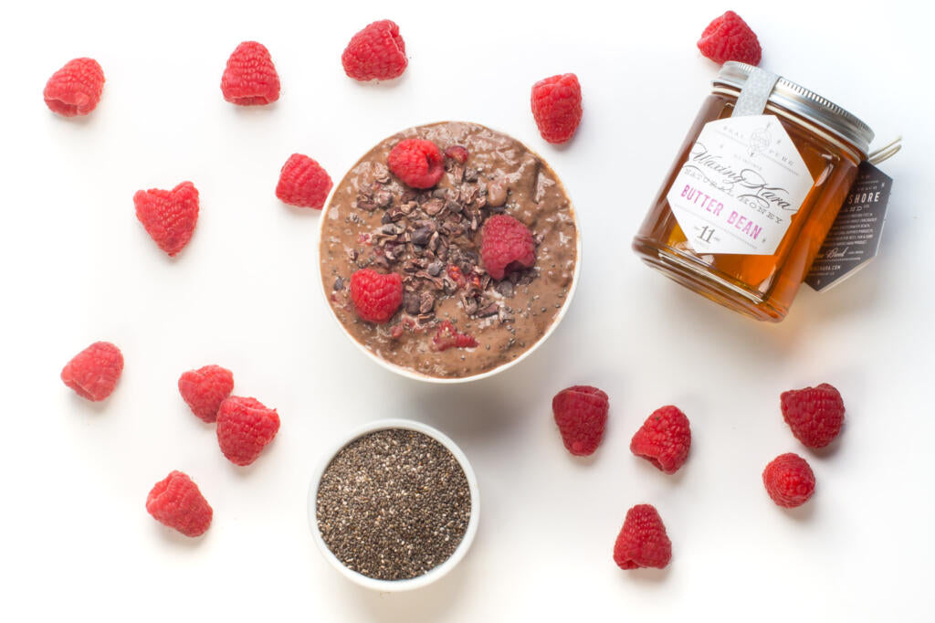 Chocolate Raspberry Chia Pudding, chia seeds, Bee Inspired honey and raspberries on the table