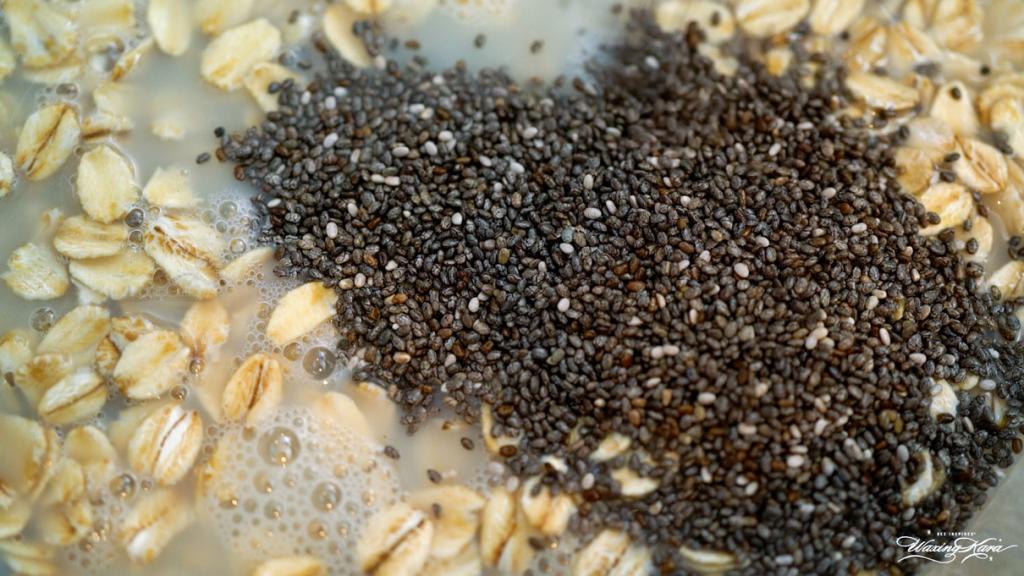 close up of chia seeds and old fashioned oats with nut milk prior to being mixed