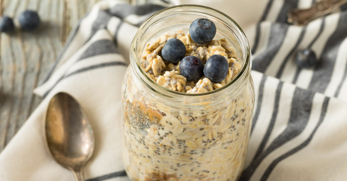 Berry Nutty Overnight Oats on striped towel with silver spoon