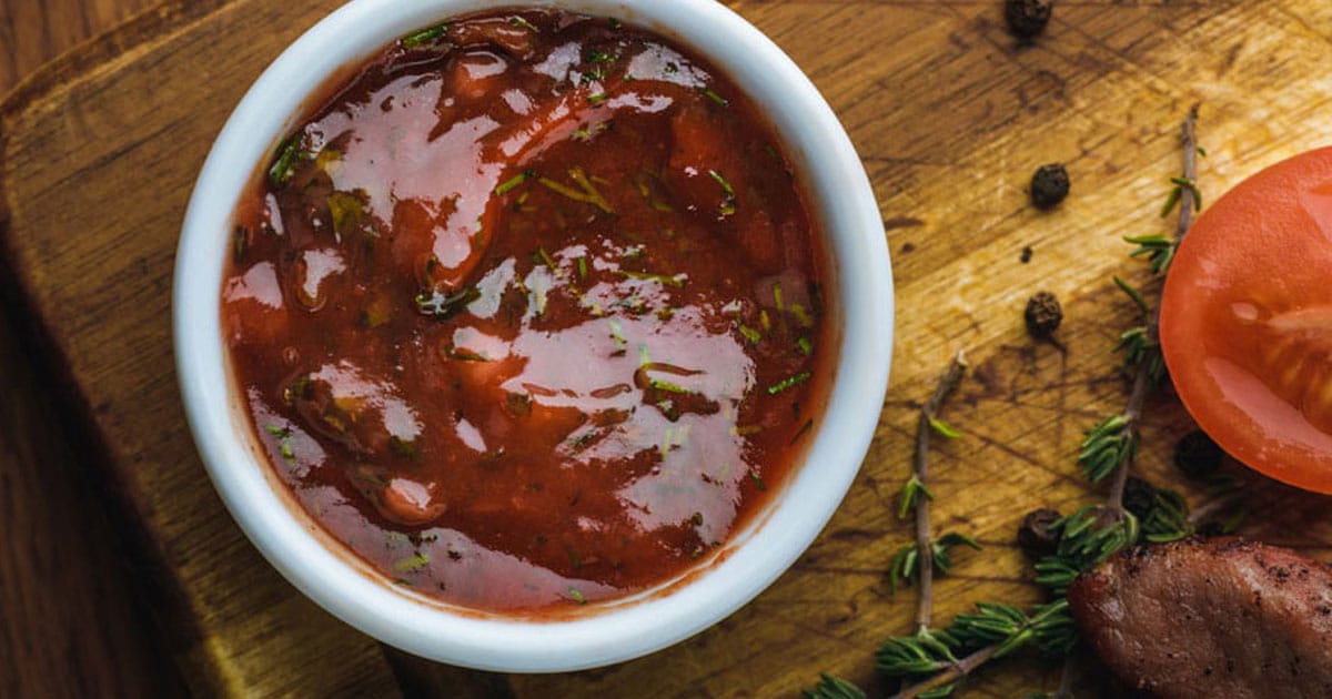 honey bbq sauce in ramekin on wood table