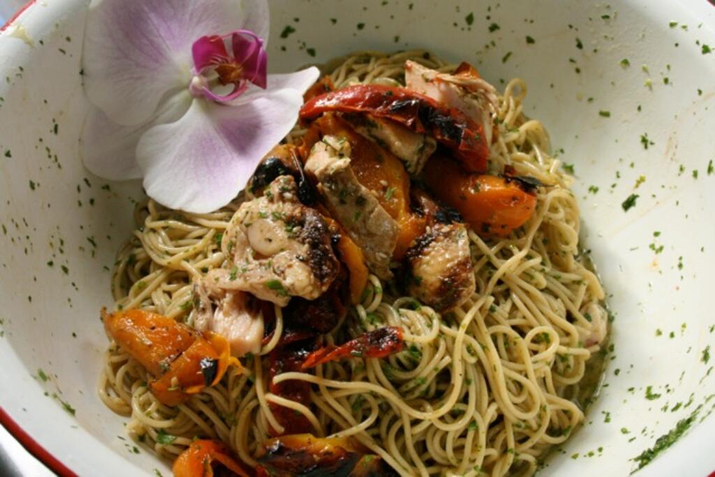 Asian Noodle Salad up close with grilled chicken and orchid