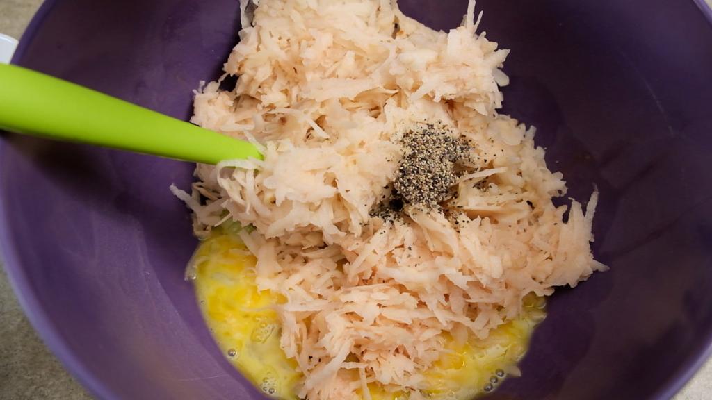 grated potato for latkes with spices and egg ready for mixing
