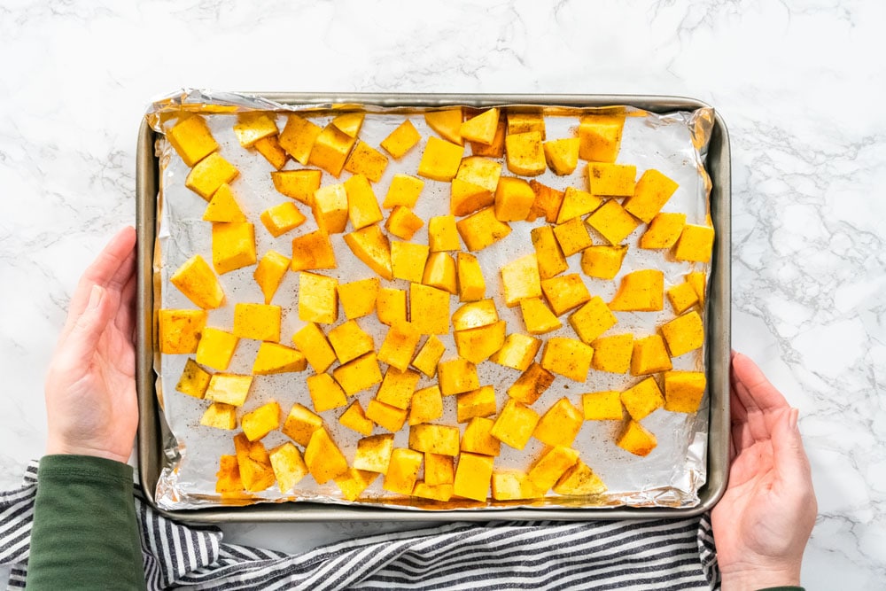 making Roasted Butternut Squash Recipe on a baking tin