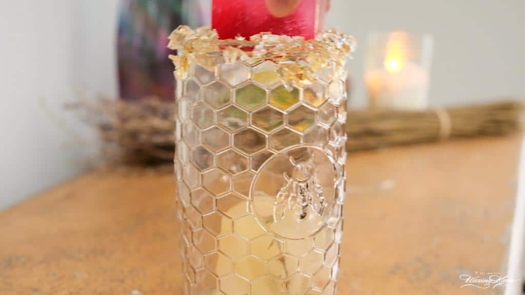 Lemon Vodka Cocktail with honey lollipop rim on counter close-up