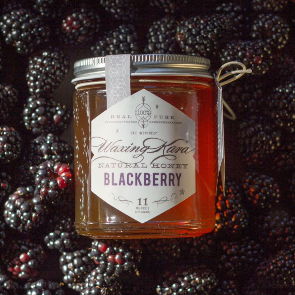 Blackberry Honey in a bed of berries