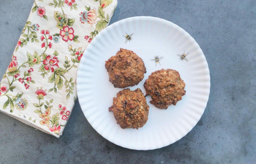 three cookies on a honeybee plate and napkin on concrete table