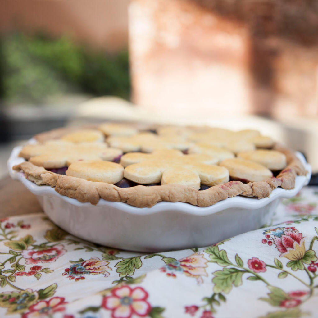 Bumbleberry Pie on flower napkin on porch, shot up close