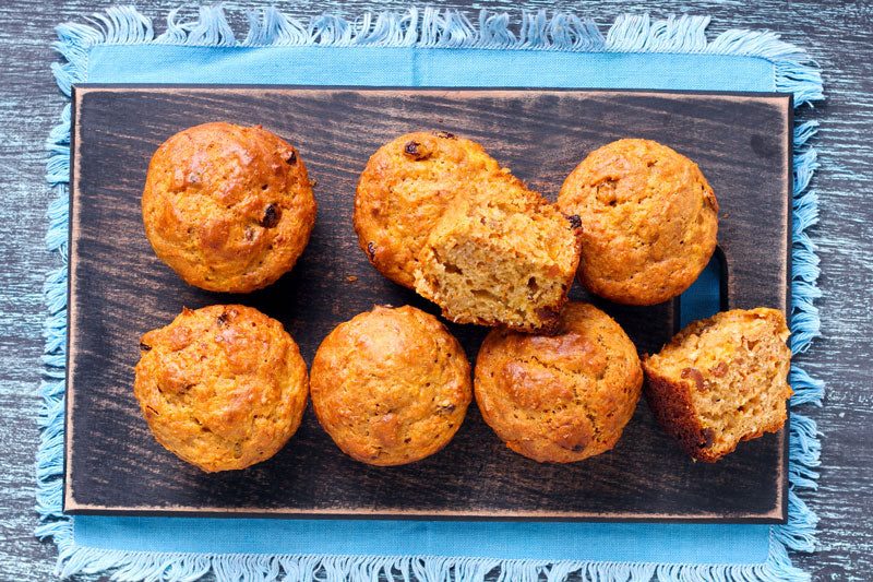 Carrot bran muffins fresh-baked and just out of the oven on blue towel