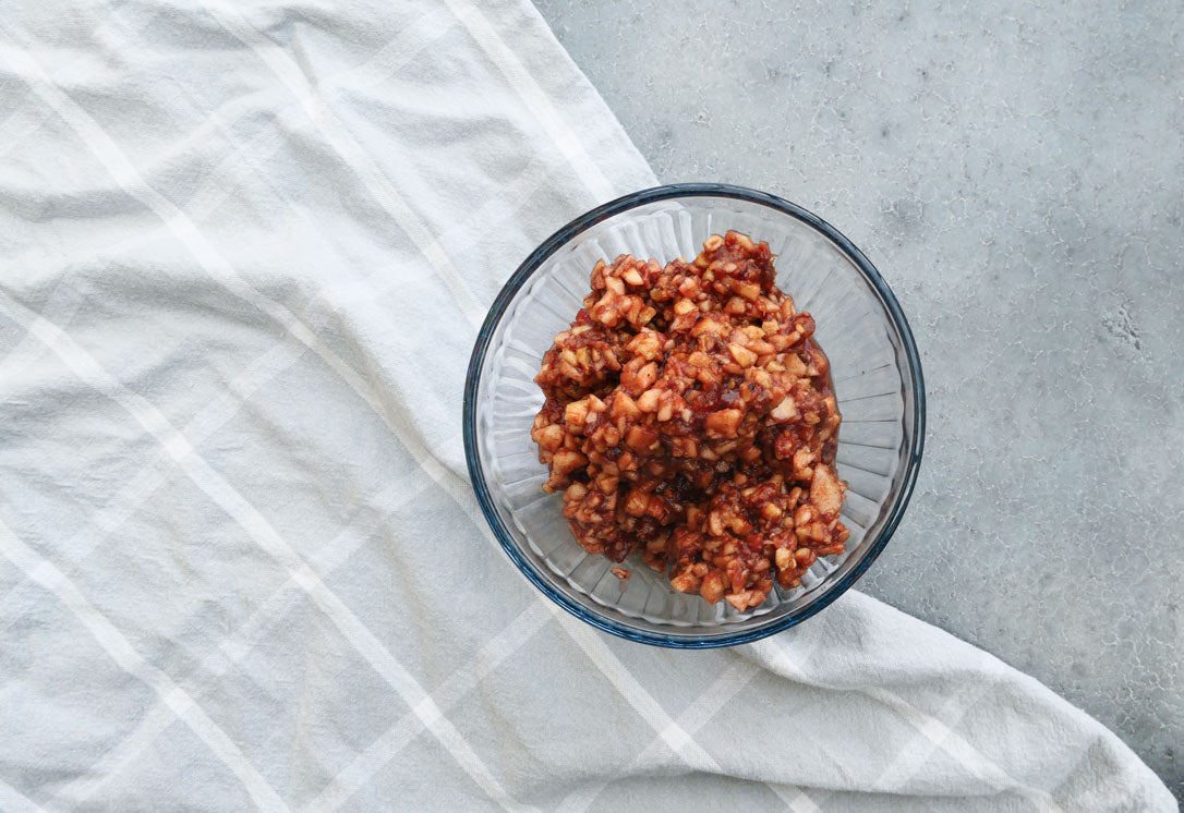 Charoset for Passover on concrete table with grey striped napkin