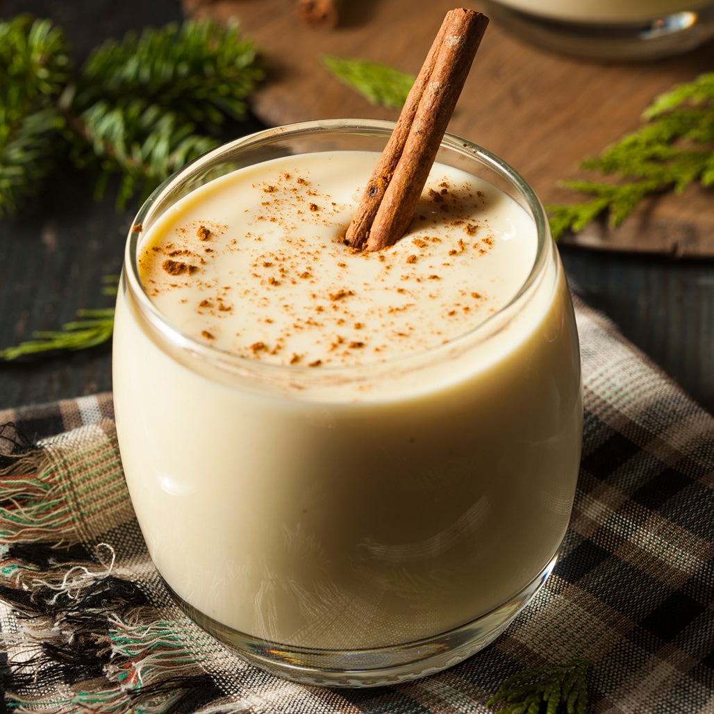 Eggnog served chilled in a glass sprinkled with cinnamon