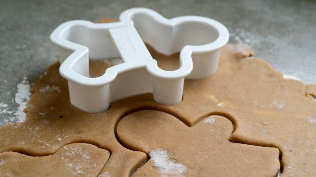 cutting gingerbread cookie men