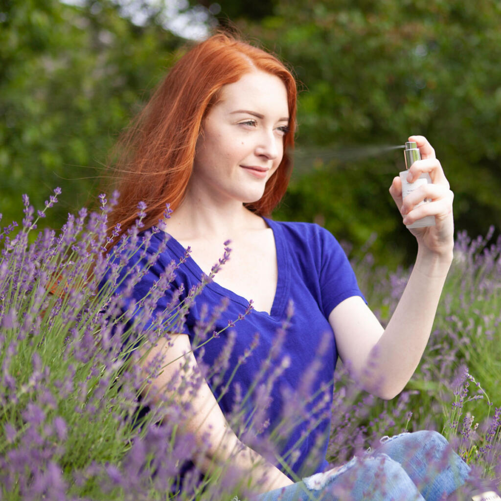 Model with lavender hydrosol spray in lavender field