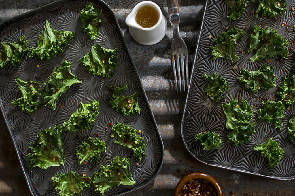 kale chips on silver tray with sauce